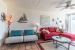 living area sectional sofa, beach wall art, end table and lamp, coffee table, ceiling fan